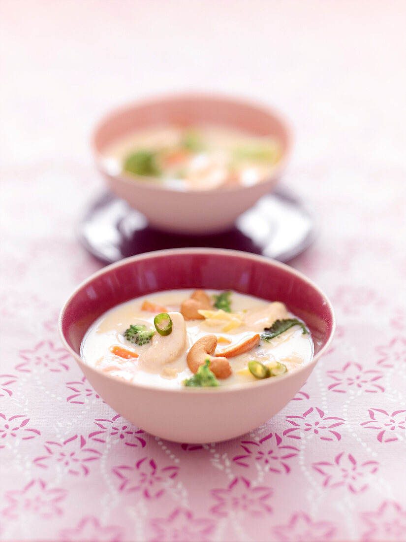 Bowl of chicken soup with cashew nuts