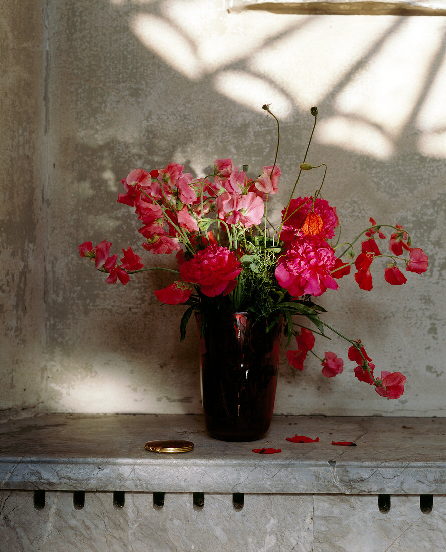 Red flowers in dark red vase
