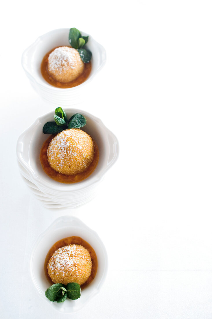 Apricot dumplings with marzipan filling on white background