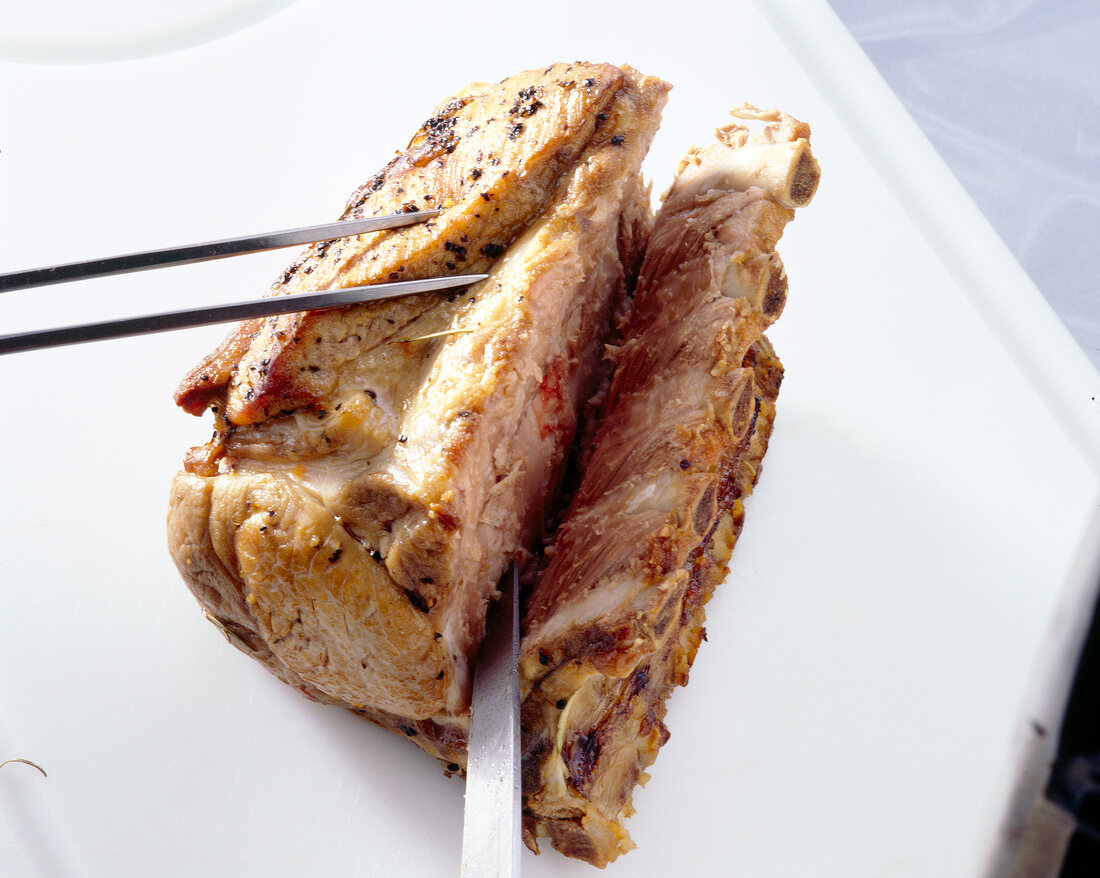 Close-up of roasted pork being sliced