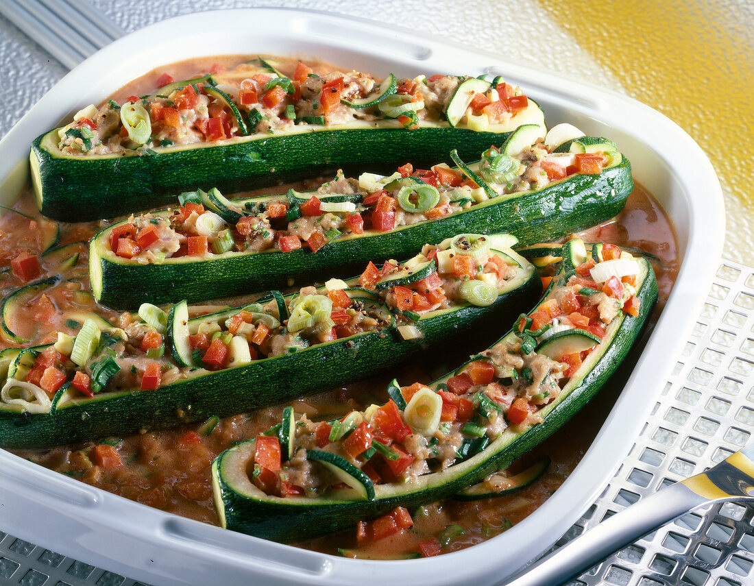 Zucchini with sausage and vegetable filling in serving dish