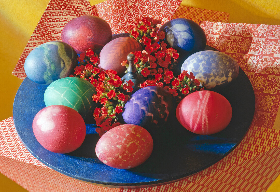 Close-up of colourful painted Easter eggs with red flowers in Asian style