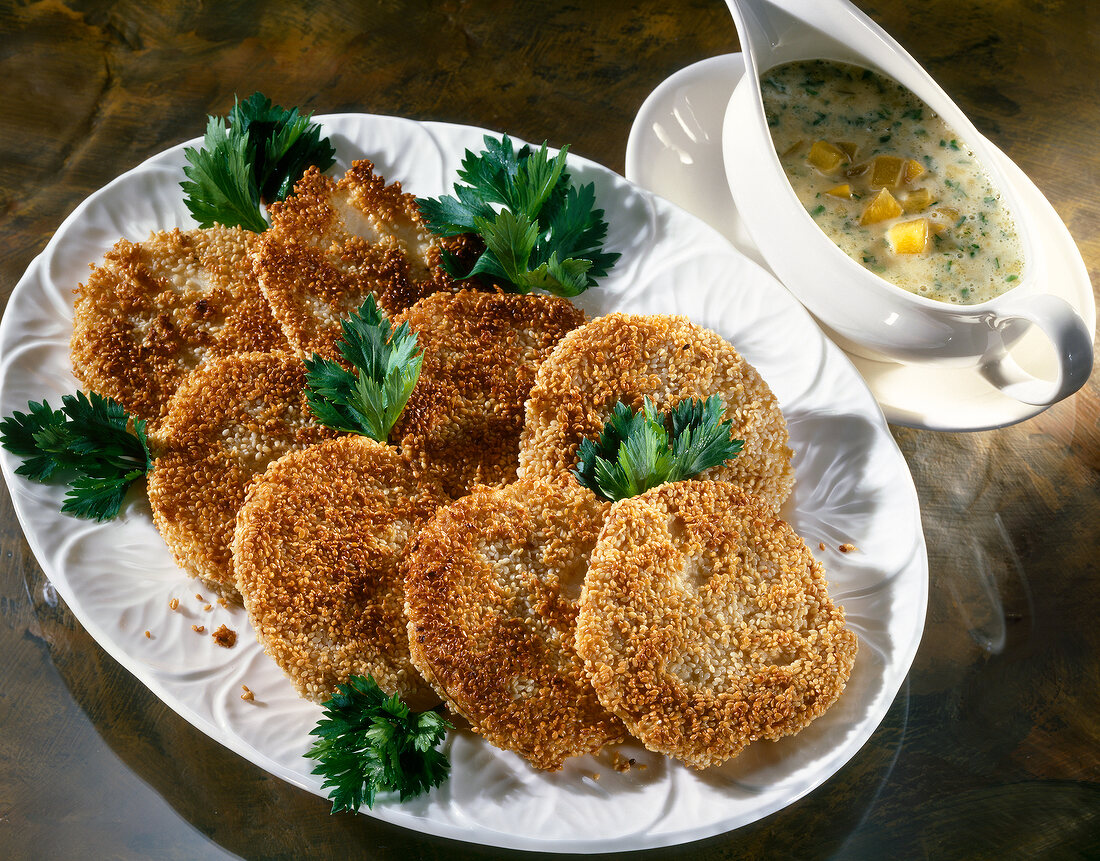 Fried celery in crispy sesame shell with herb mayonnaise on plate