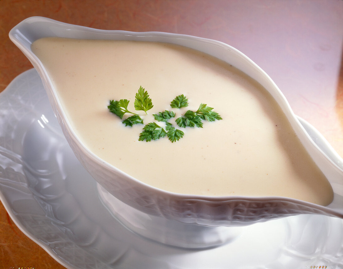 Cheese sauce with gouda and parsley in serving dish
