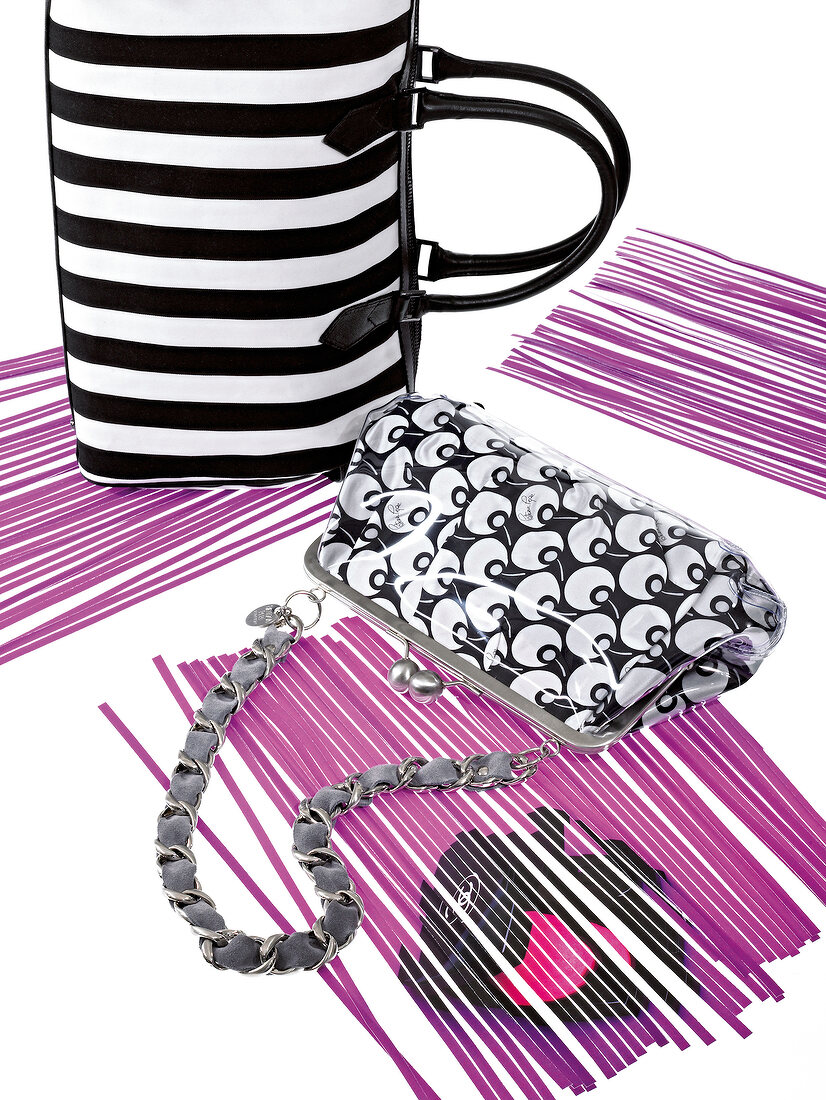 Black and white striped handbags on purple paper strips
