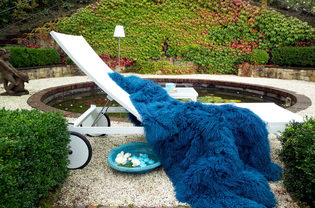 Blue blanket on sun lounger in garden