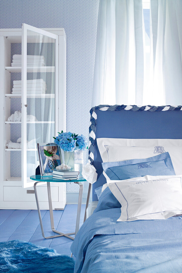 Interior of blue bedroom with white cabinet