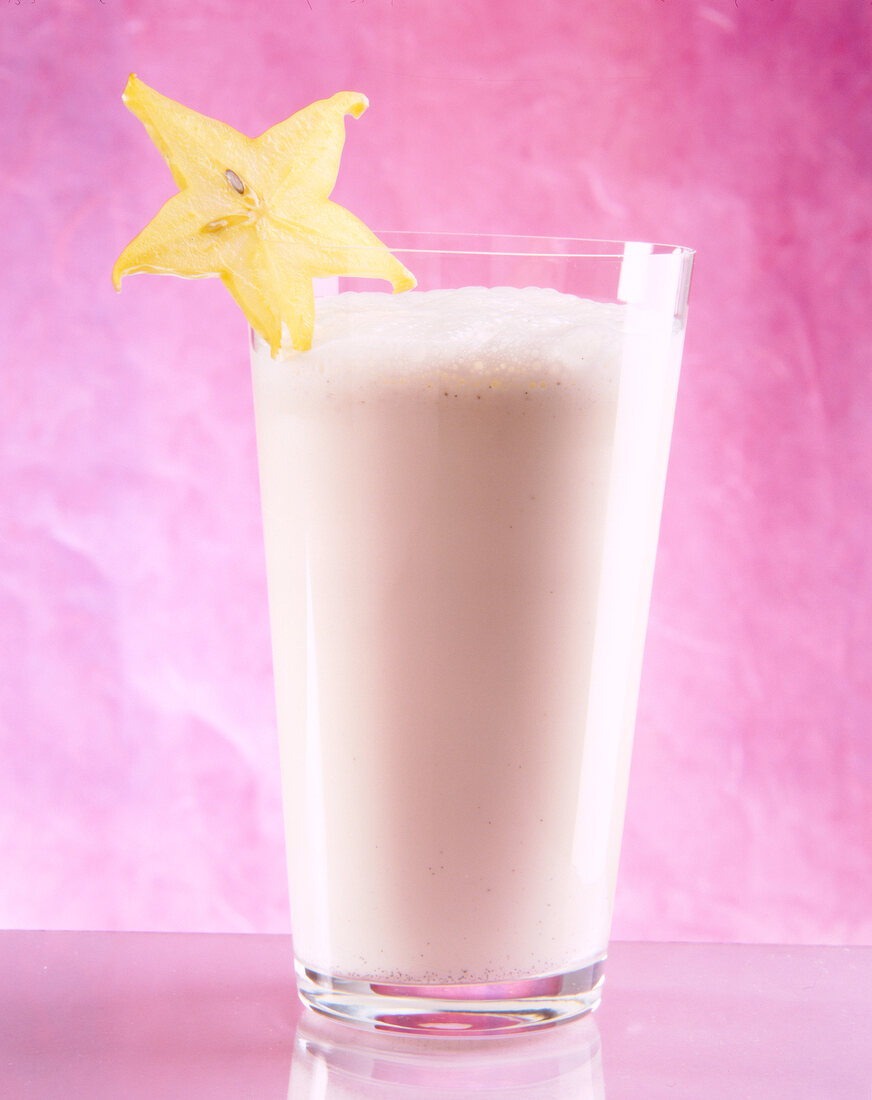 Glass of vanilla and passion fruit juice garnished with star fruit