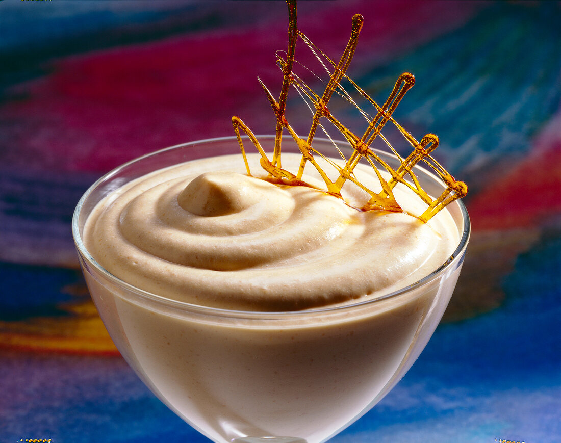 Close-up of caramel cream garnished with caramel lattice in bowl