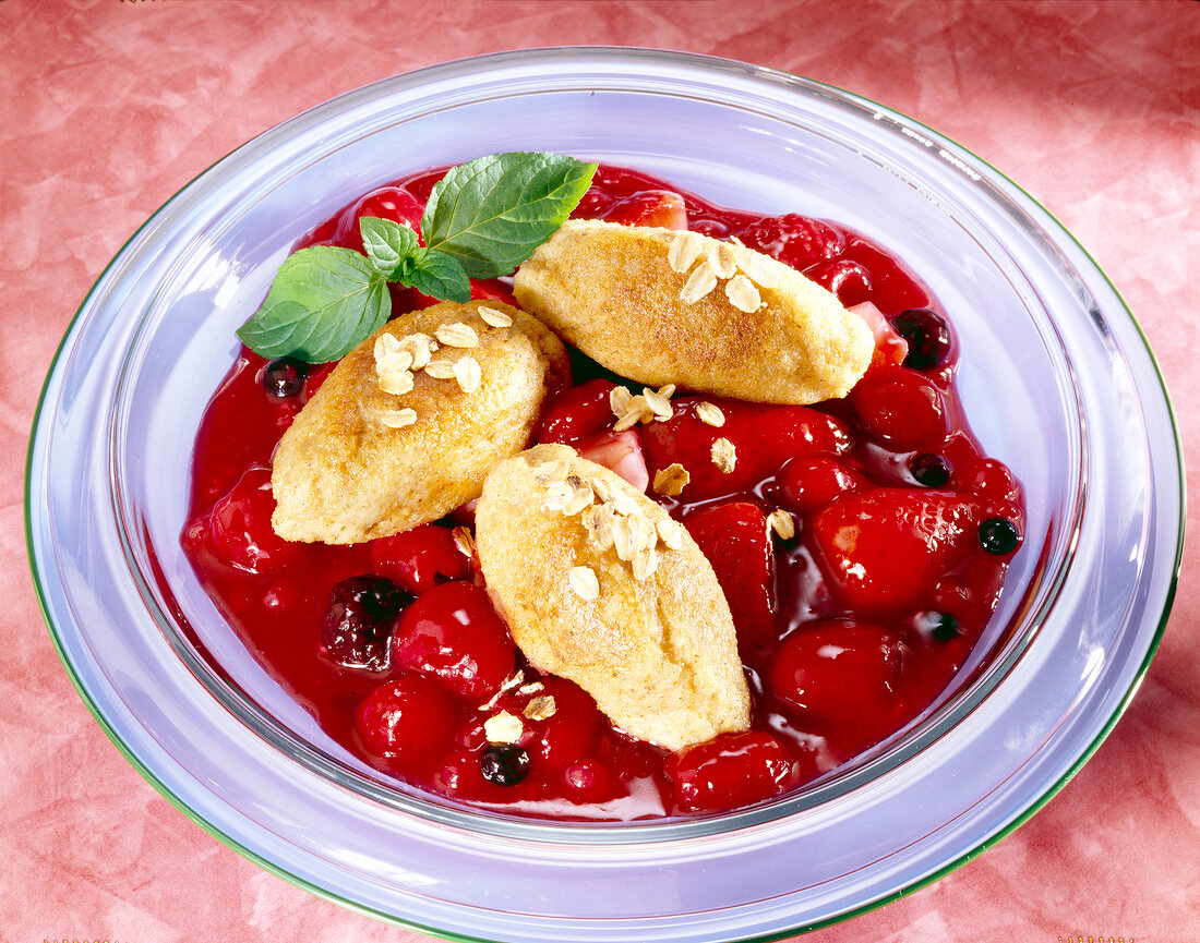 Semolina dumplings with berry compote in serving dish