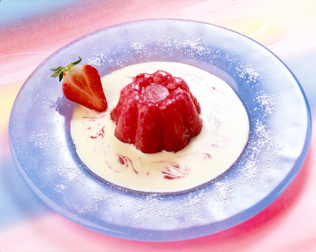 Rhubarb jelly with custard and strawberry puree on plate