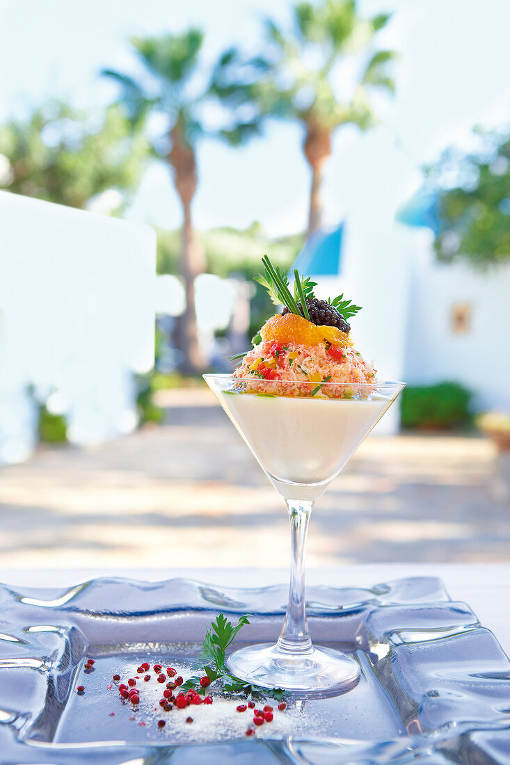 Shrimp cocktail and caviar on cauliflower cream in glass