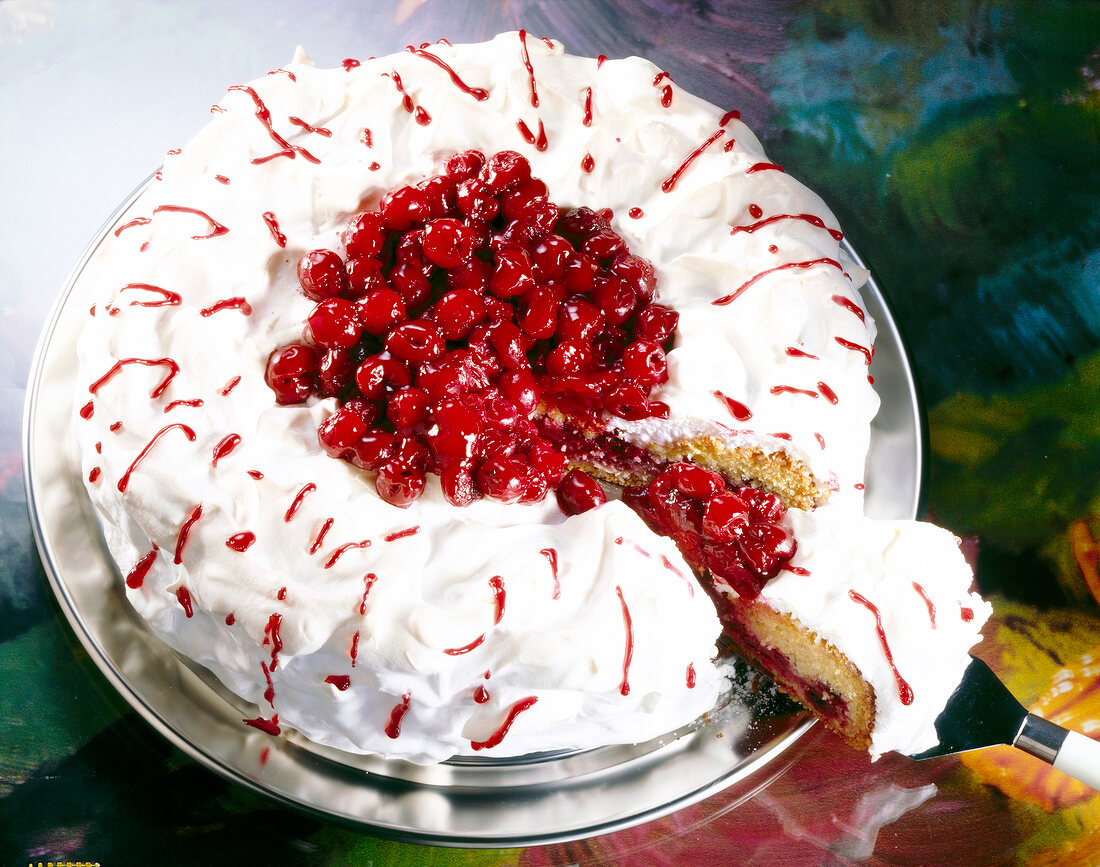 Close-up of cherry meringue pie with cherries on serving dish