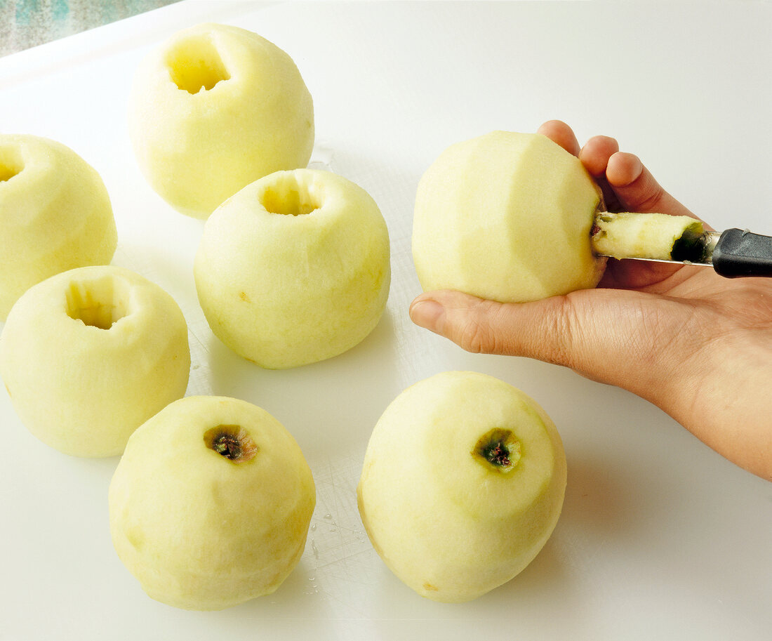 Scooping peeled apples for apple pie