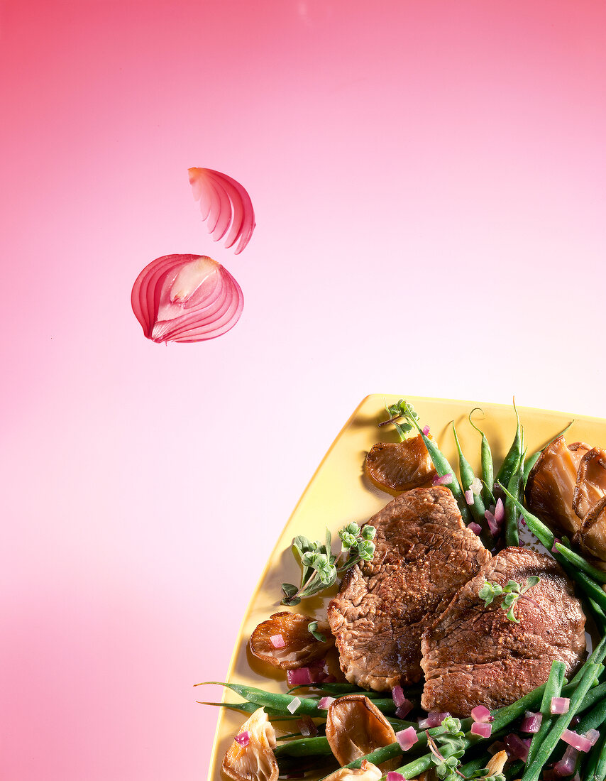 Beef steak with beans and mushrooms on plate