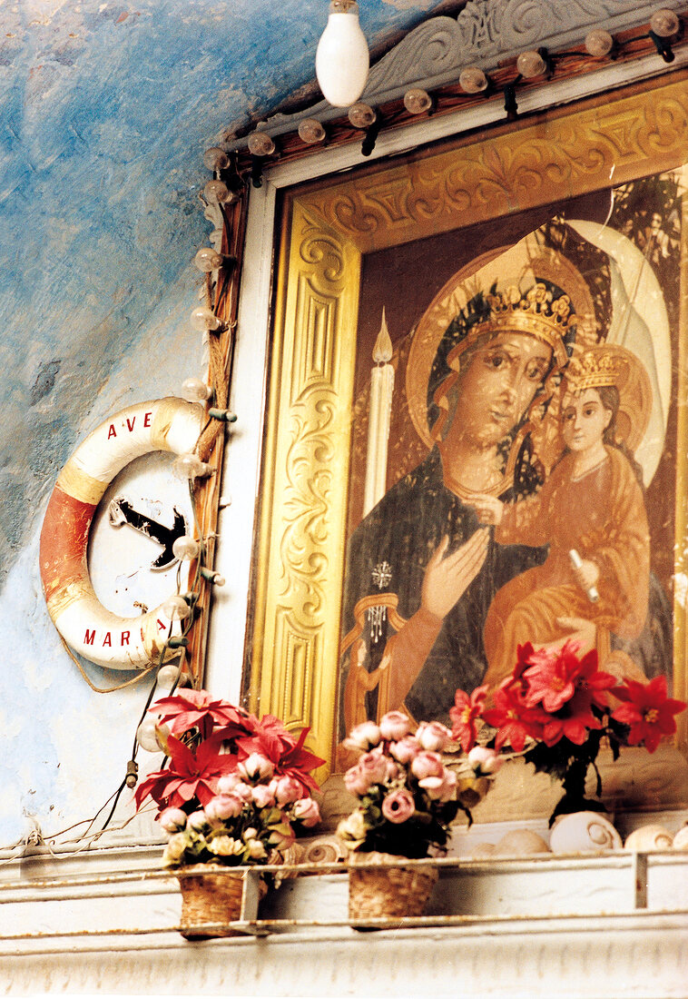 Photo frame of Madonna with child on wall