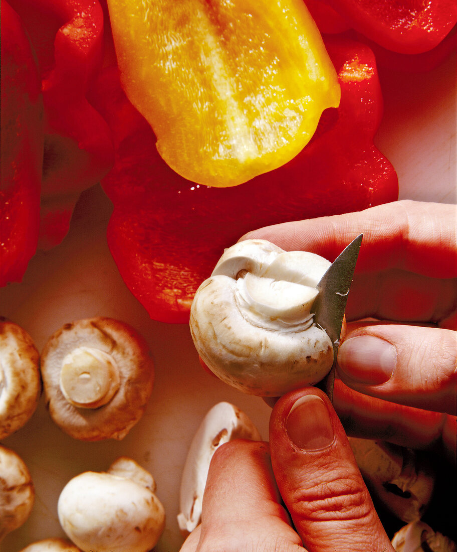 Close-up of cutting mushroom in halves