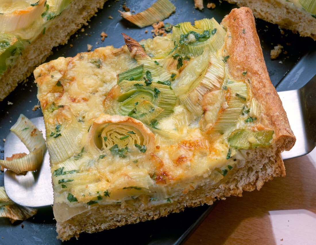 Close-up of piece of leek and onion tart