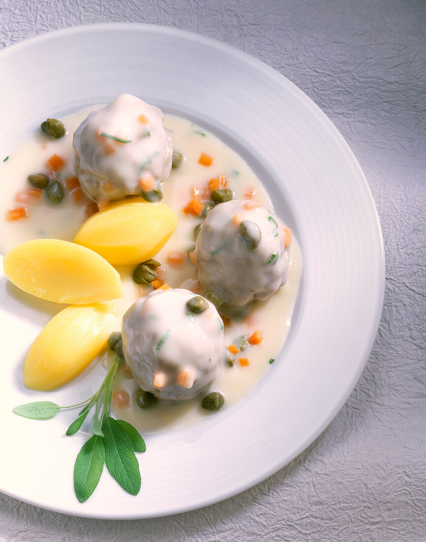 Konigsberg style meatballs with potatoes on plate