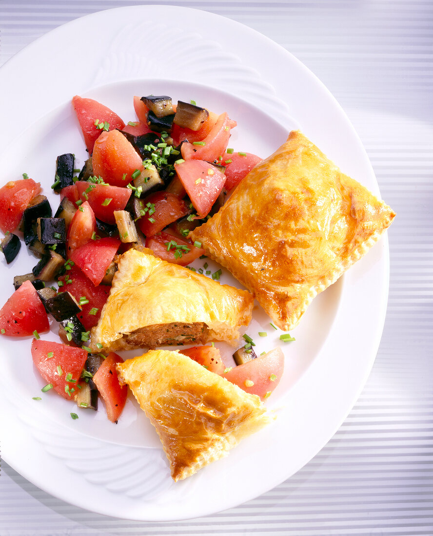Puff pastry with tomatoes and aubergines on plate