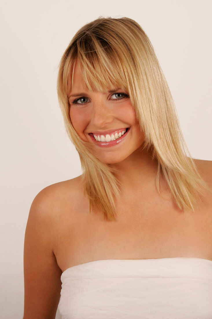 Portrait of beautiful green eyed blonde woman, smiling