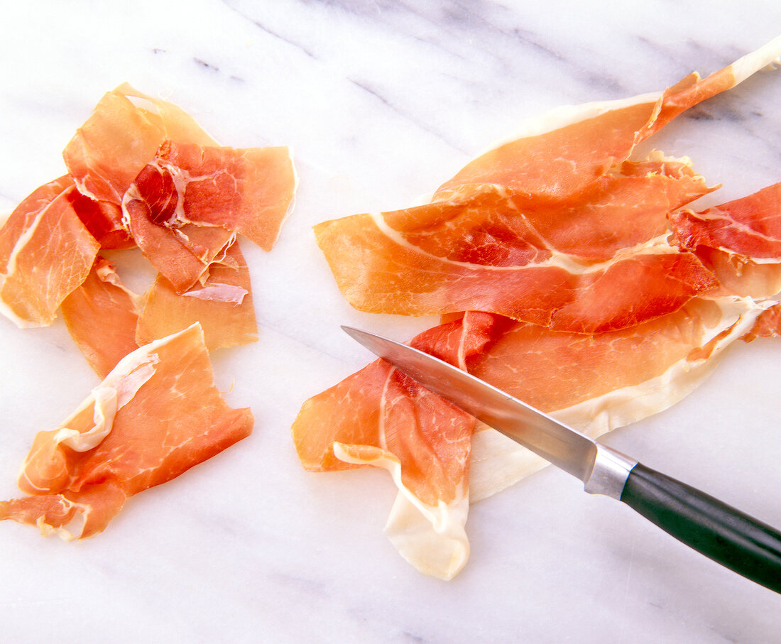 Cutting ham to wide strips with knife