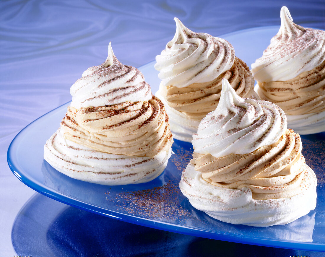 Close-up of filled meringues with coffee cream liqueur on plate