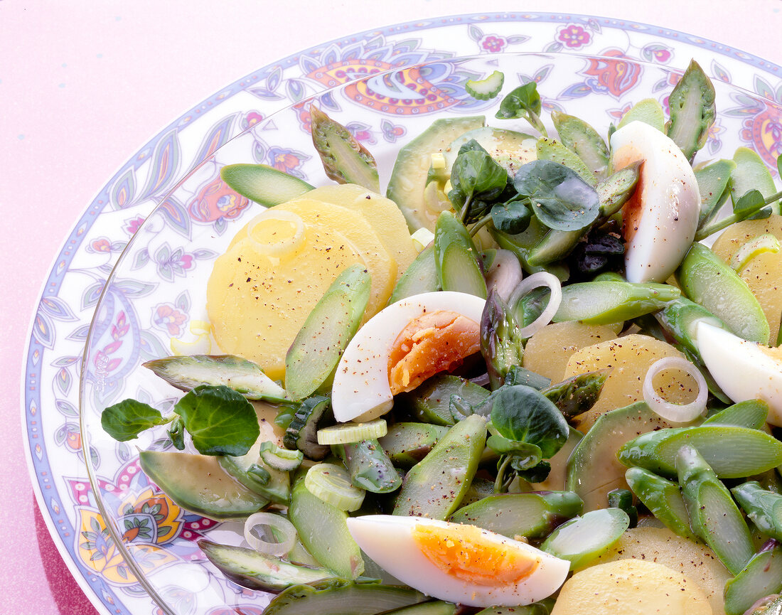 Close-up of asparagus salad with avocados and potatoes on plate