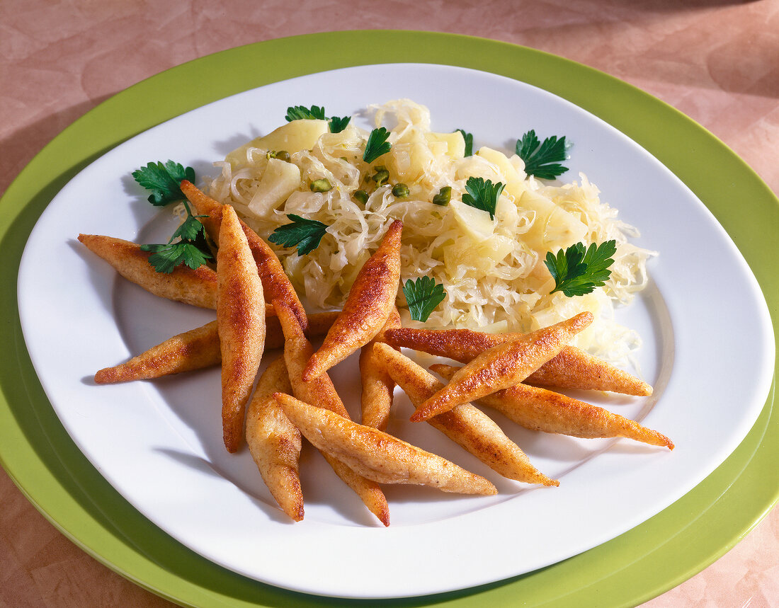 Potato noodles, sauerkraut, apple and parsley on dish