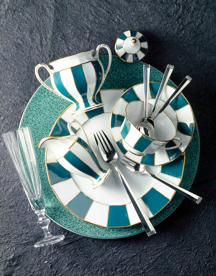 Green and white striped plate, cup and saucer with champagne glass and cutlery