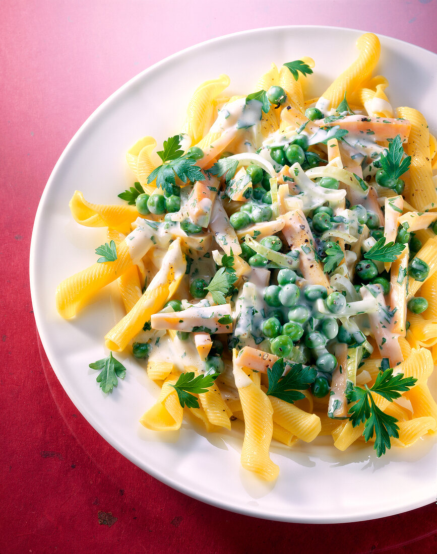 Pasta with vegetables and cheese sauce on plate