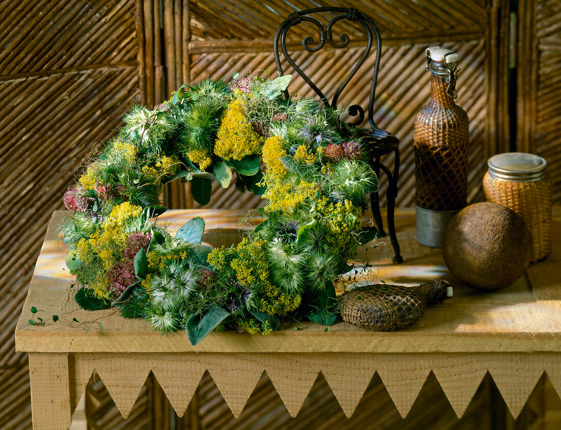 Bauer dried wreath with jar, bottles and small chairs on table