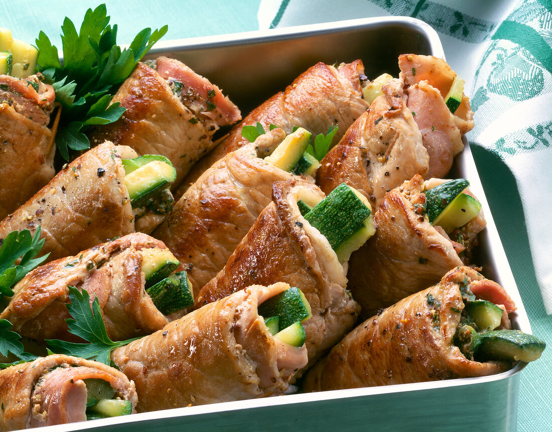 Close-up of schnitzel filled zucchini in baking tray