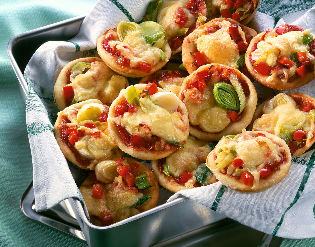 Appetizers toppes with vegetables and cheese