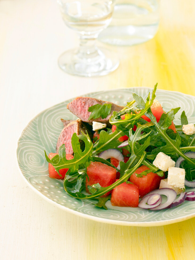 Close-up of melon and feta salad with lamb