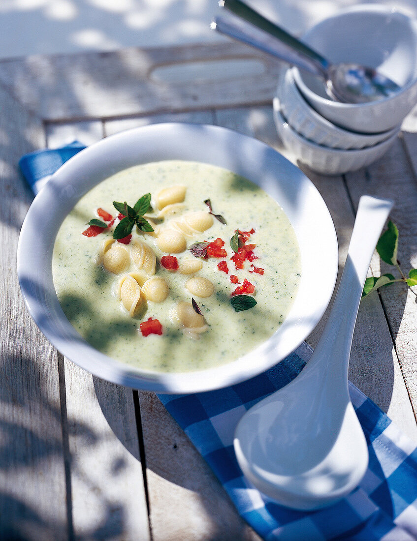 Chilled zucchini soup served with noodles and mussels in bowl