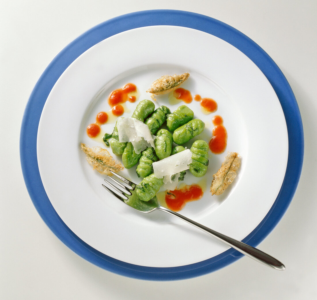 Spinach gnocchi with sage on plate