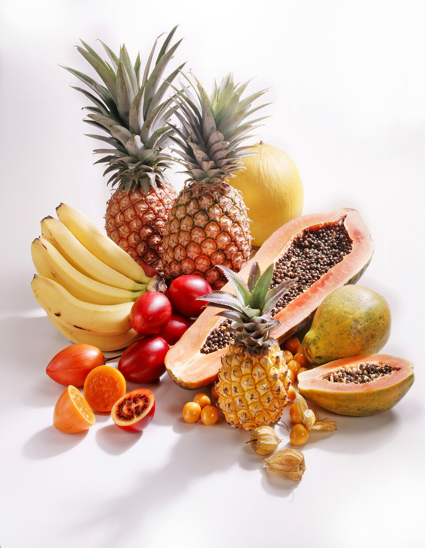 Pineapple, bananas, papaya and other exotic fruits on white background