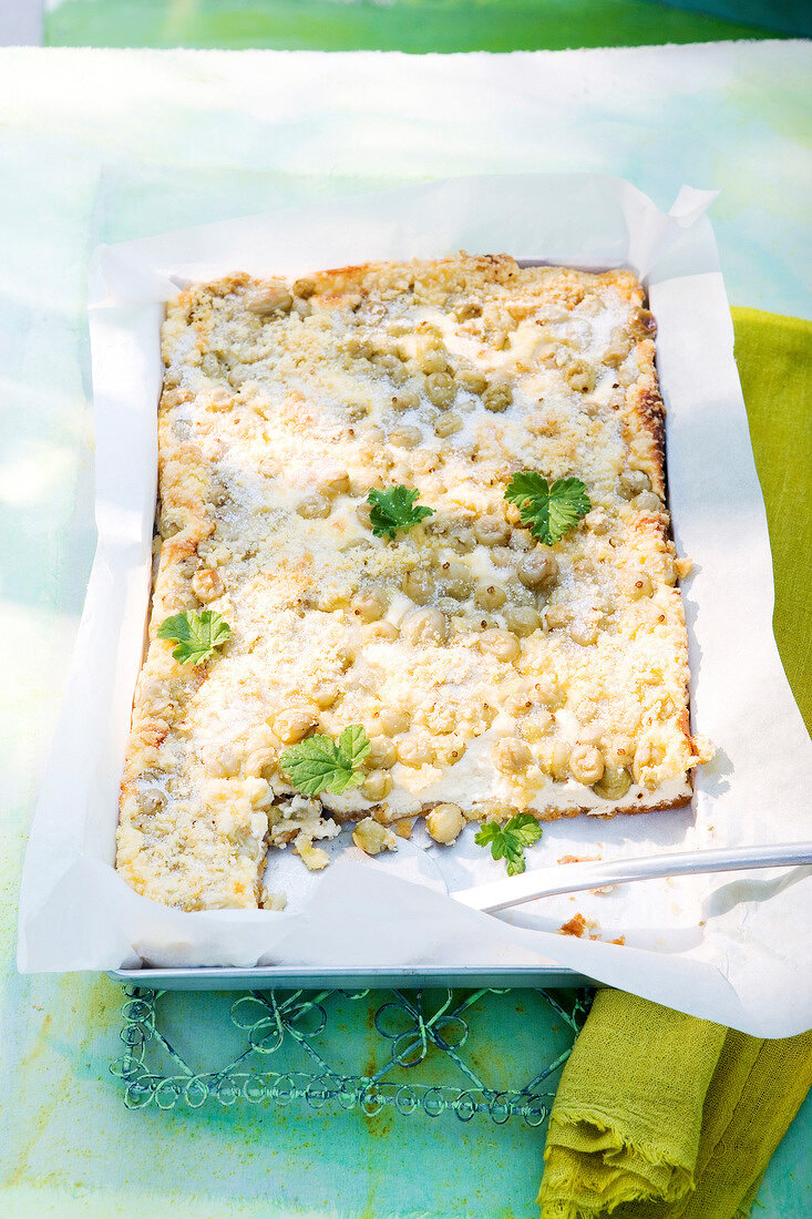 Gooseberry crumble cake with curd in baking dish