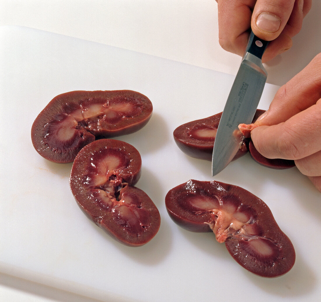 Venison kidneys with mustard being cut into pieces, step 1