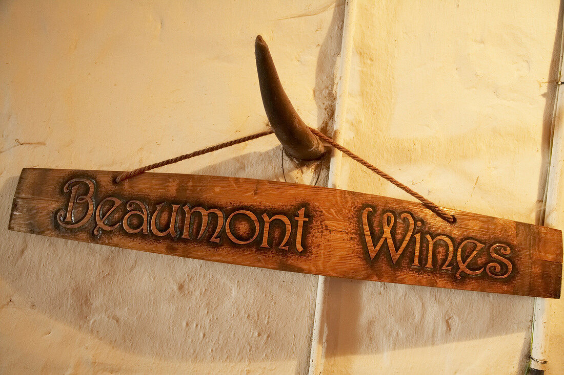 Wooden name plate of Beaumont Wines hanging on a horn in Winery Beaumont, South Africa