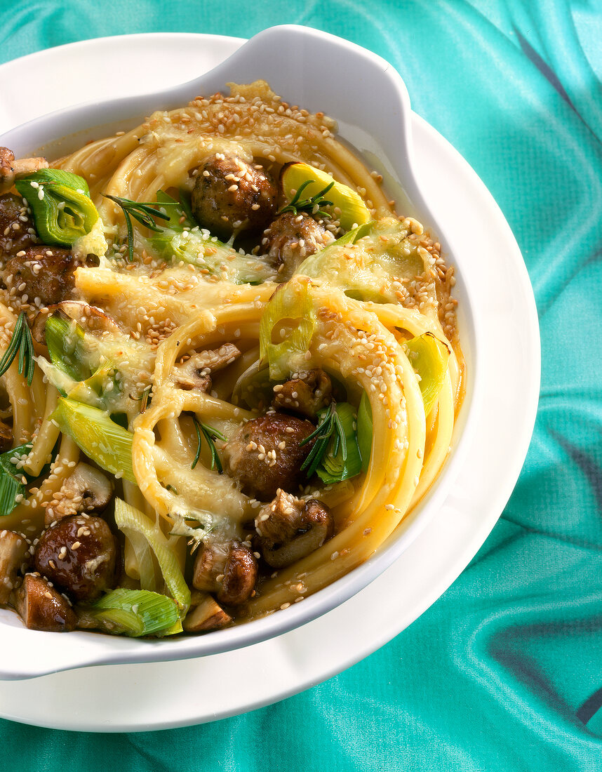 Close-up of baked macaroni with sesame seeds in bowl