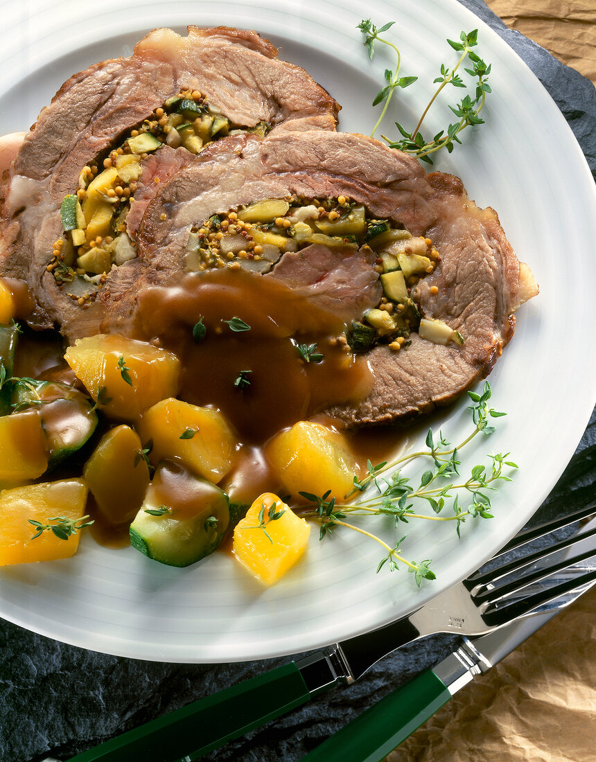 Close-up of stuffed pork with pumpkin on plate