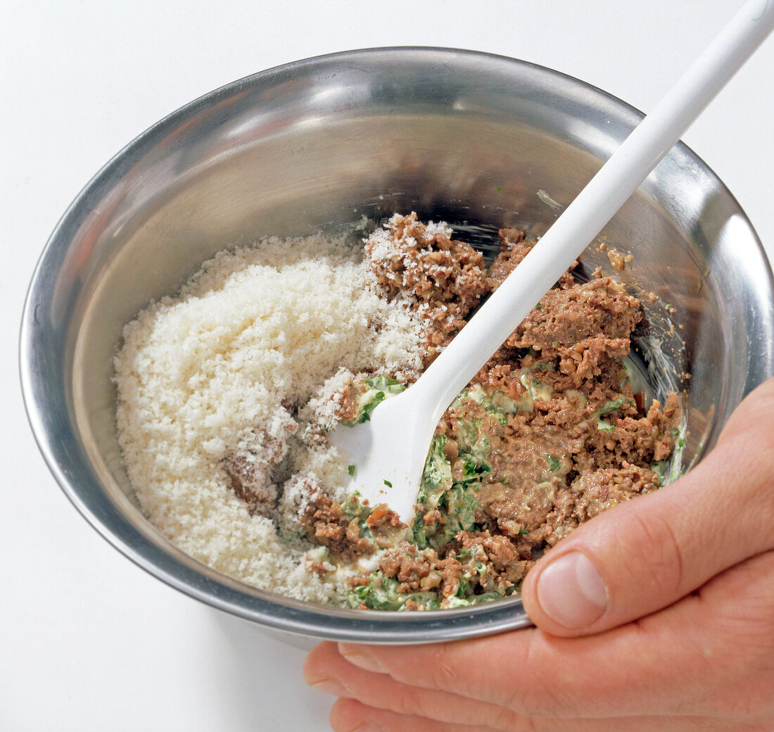 Stuffing being prepared with bread crumbs in bowl, step 3