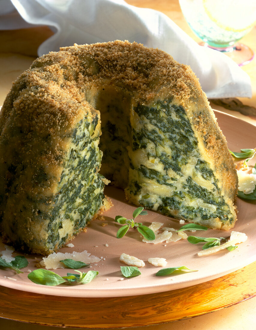 Close-up of spinach pudding with watercrest on plate