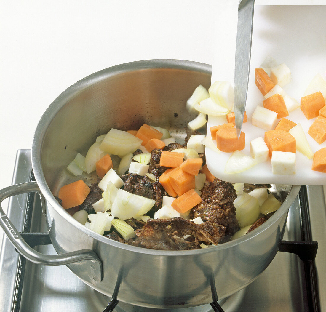 Vegetables added to mixture in pot, step 3