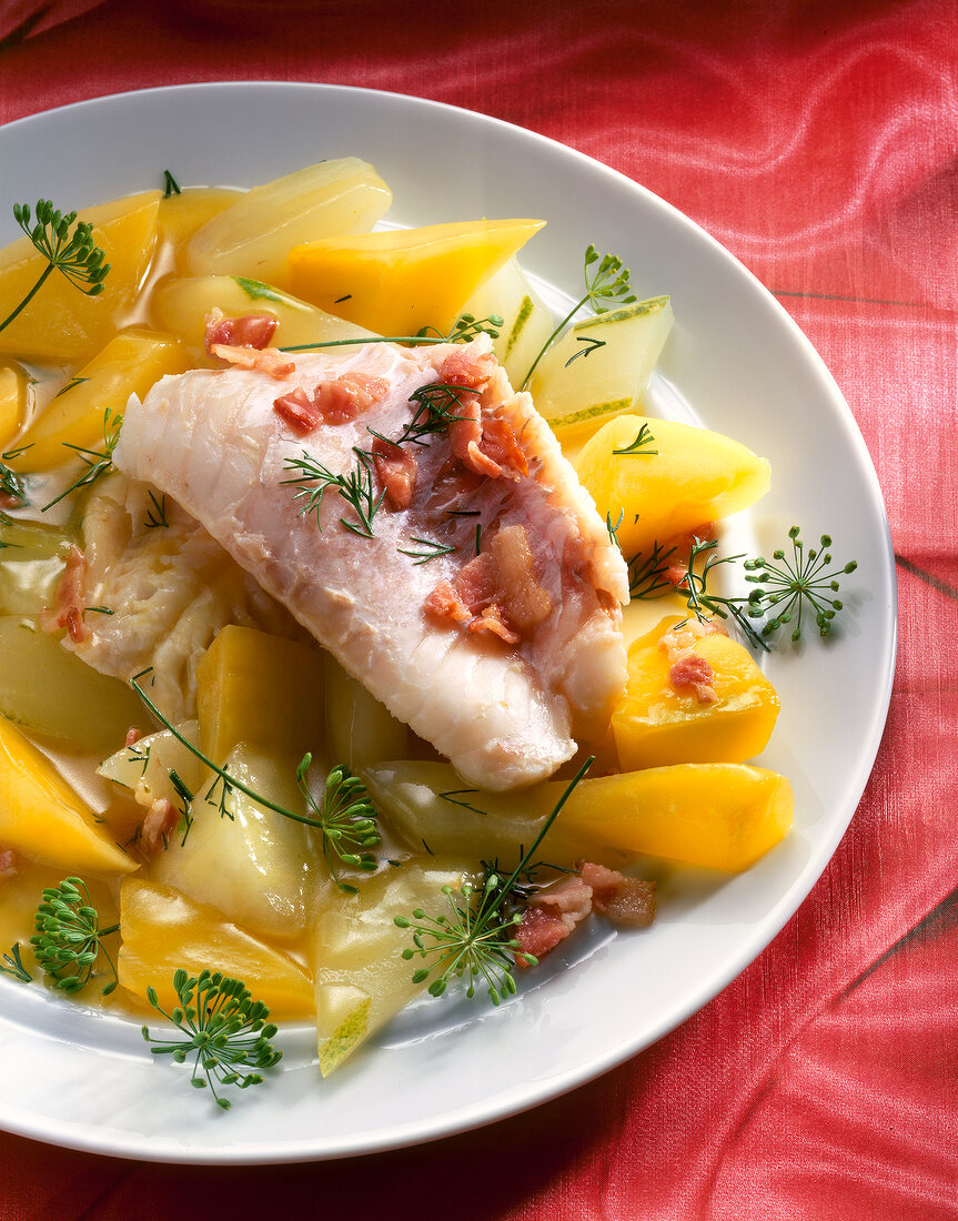 Close-up of redfish fillet with vegetables on plate