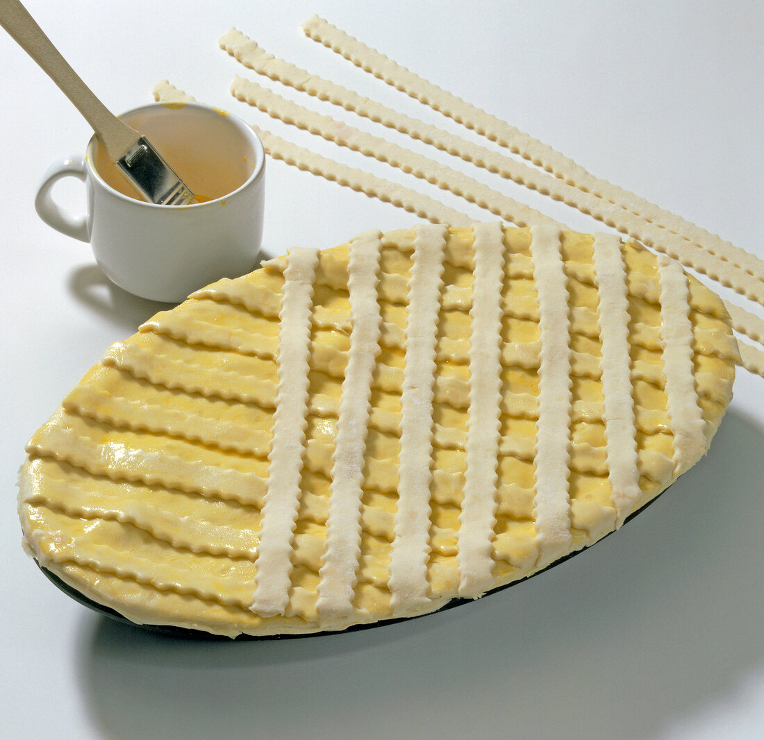 Dough strips decorated on serving bowl for preparation of partridge pie, step 8