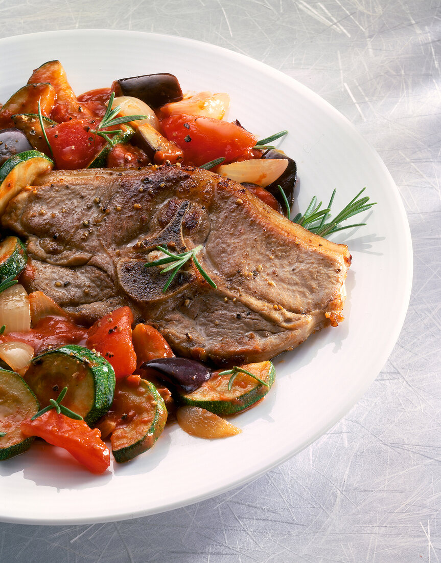 Close-up of lamb chops with ratatouille on plate