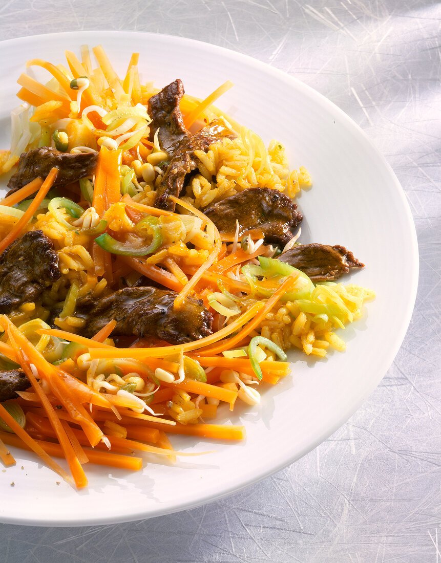 Close-up of fried rice with beef and vegetables on plate